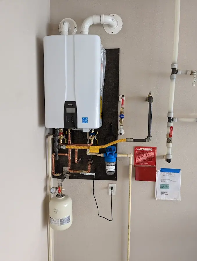 Professional plumber installing copper piping in a Choccolocco home